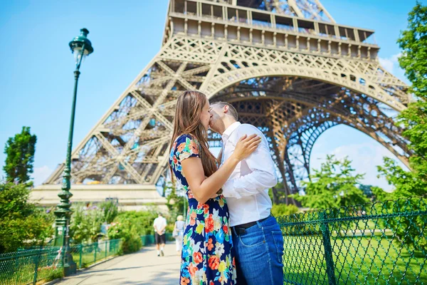年轻对浪漫的情侣接吻在艾菲尔铁塔下 — 图库照片