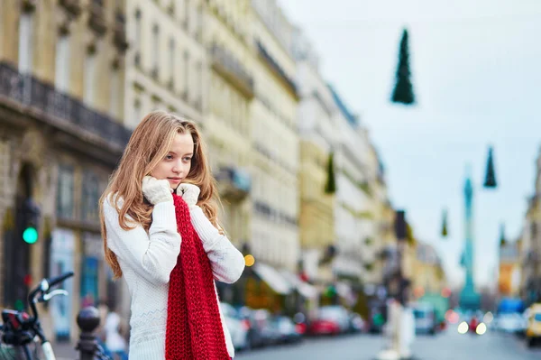 Beautiful young girl in red scarf on a Parisian street — Stock Photo, Image