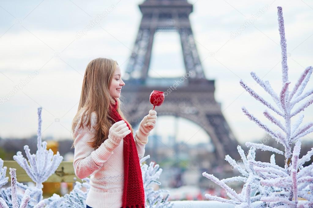 Girl with caramel apple on a Parisian Christmas market 