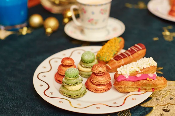 Table à manger de Noël décorée avec de délicieuses éclairs — Photo