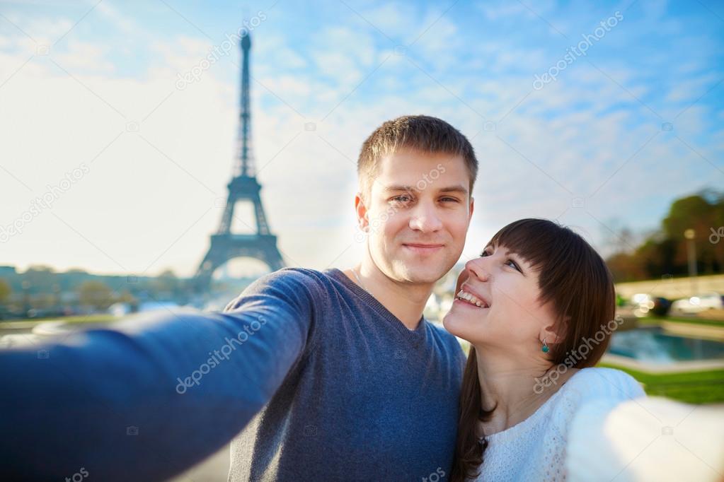 Young romantic couple taking funny wide angle selfie