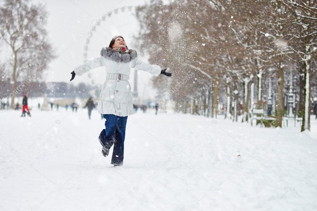 Girl enjoying rare snowy winter day in Paris