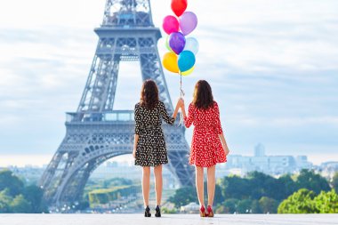 Twins with colorful balloons in Paris clipart