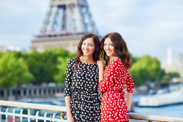 Twin sisters in front of the Eiffel tower in Paris, France — Stock Photo, Image