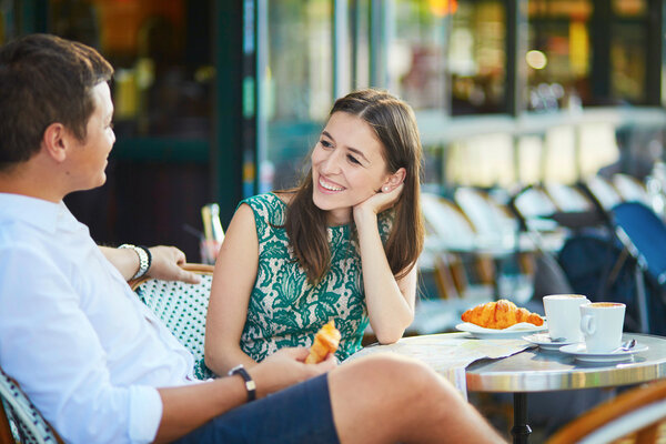 Young romantic couple in Parisian cafe