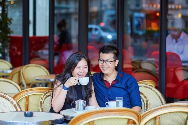 Young romantic Asian couple in Parisian cafe — Stock Photo, Image