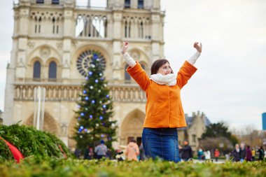 Happy young tourist in Paris on a winter day clipart