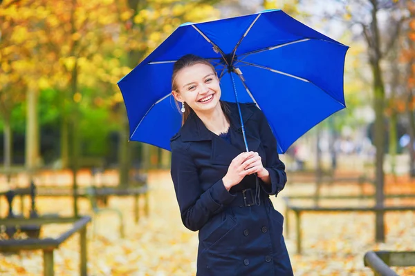 Beautiful young woman with blue umbrella — Stock Photo, Image