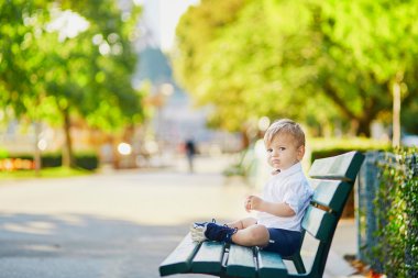 Bankta oturan sevimli küçük çocuk