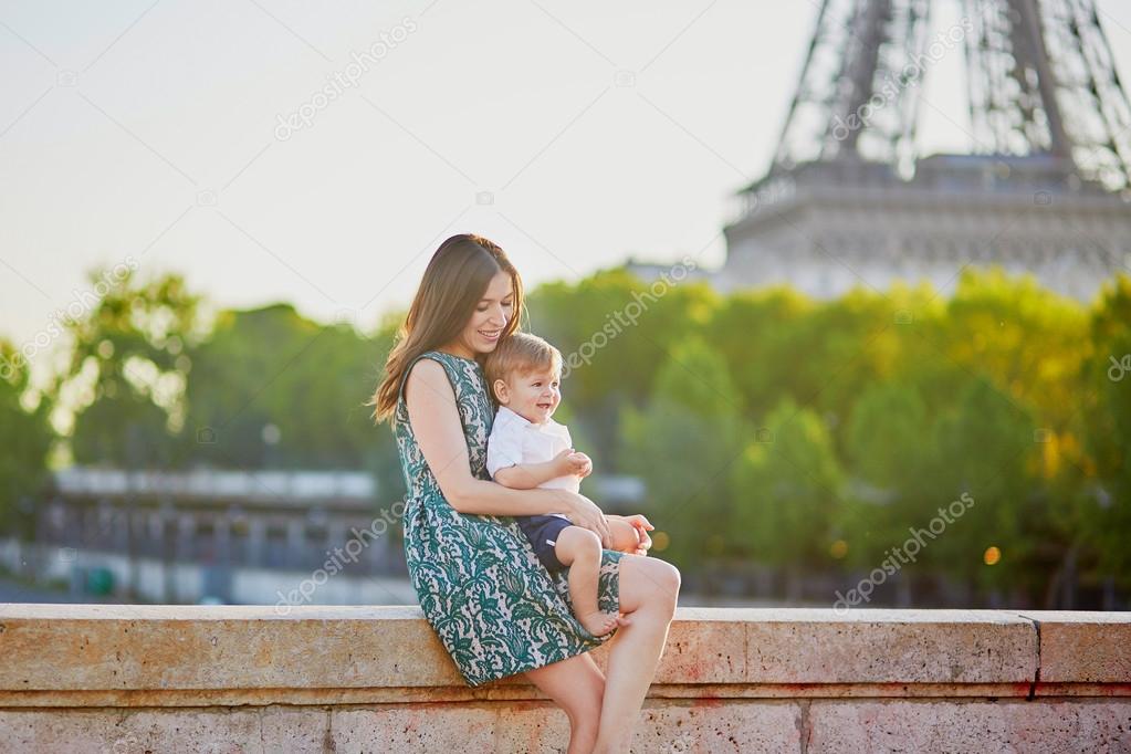 Beautiful young mother with her adorable in Paris, France