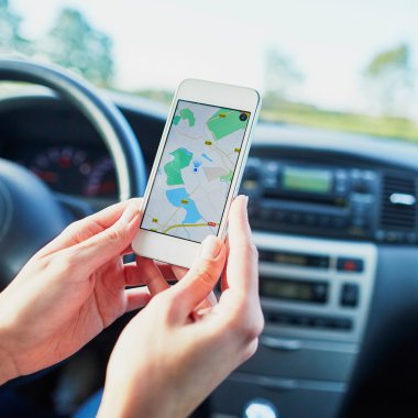 Kadın sürücü navigator ile bir telefon bir ekranda tutan eller
