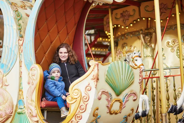 Young mother with her adorable little son on Parisian merry-go-round — Stock Photo, Image