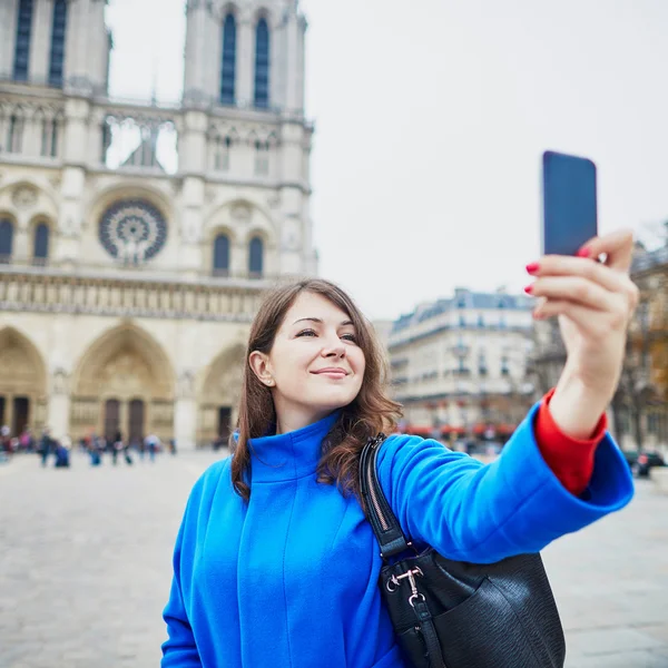Tourist in Paris, making funny selfie near Notre-Dame cathedral — Stock Photo, Image