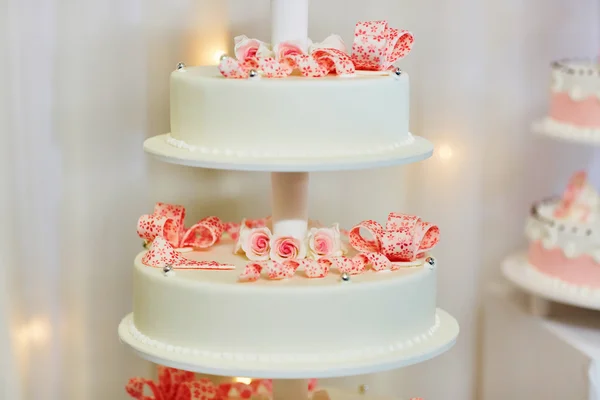 Weiße Hochzeitstorte mit rosa Rosen dekoriert — Stockfoto