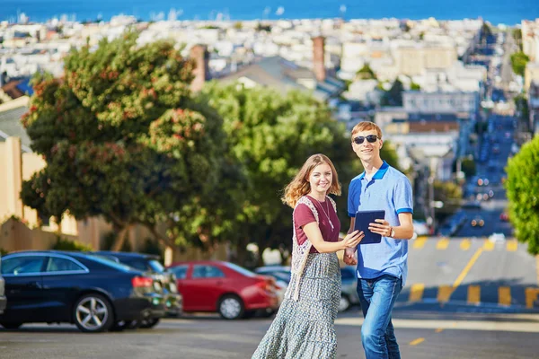 Romantic couple of tourists using tablet in San Francisco, California, USA — Stock Photo, Image