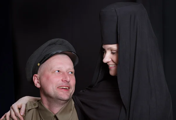 Woman in a monk robe and soldier. — Stock Photo, Image