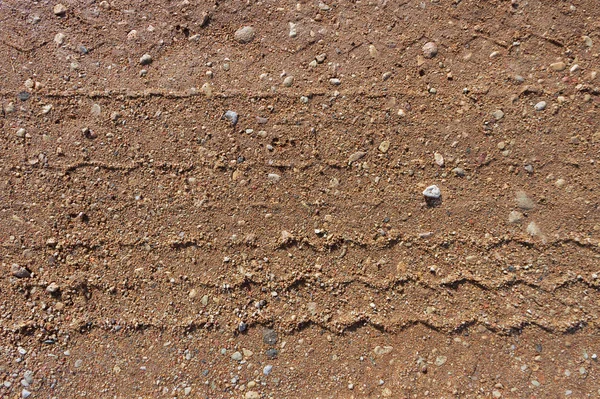 Superfície de estrada de cascalho com trilha de roda . — Fotografia de Stock