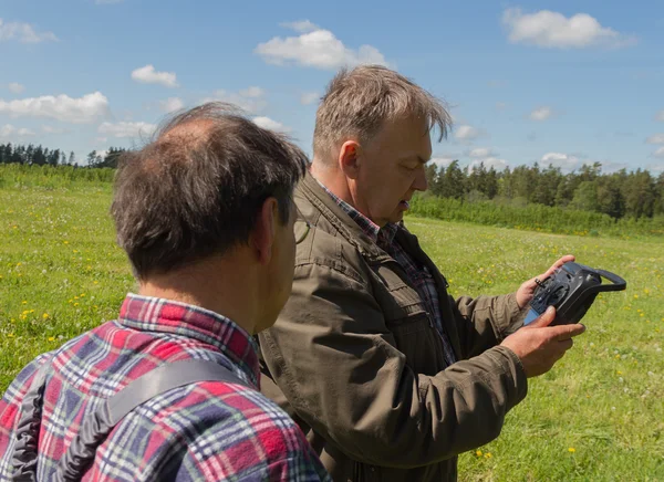 Two men launch drone. — Stock Photo, Image