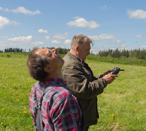 Two men launch drone. — Stock Photo, Image