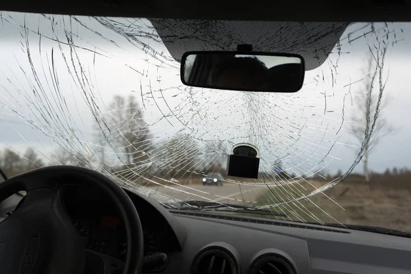 Broken windshield of car from inside.