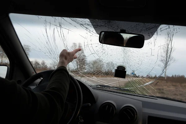 Broken windshield of car from inside.