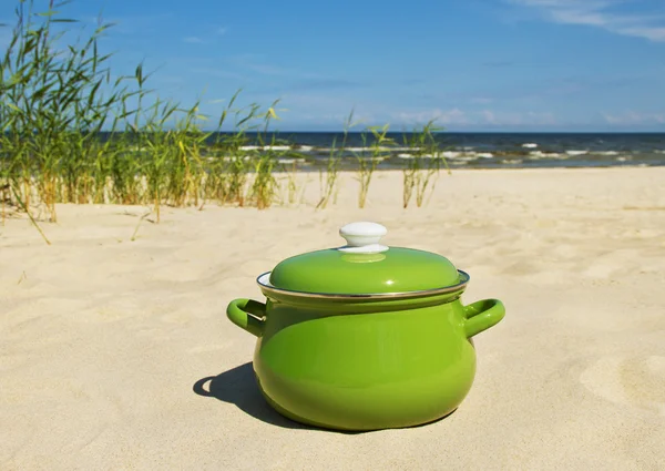 Green pot on a sand. — Stock Photo, Image