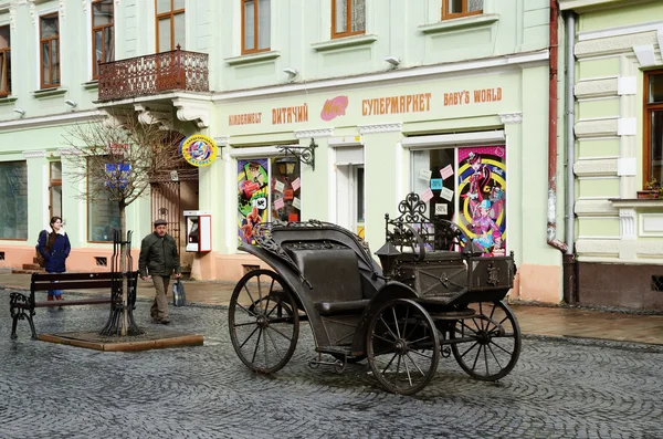 Olga Kobylyanska avenida (só uma rua pedestre na cidade) com carruagem de ferro - presente de guilda de ferreiro em primeiro de dezembro em Chernivtsi, ucraniana.É centro histórico de Chernivtsi e rota de passeio popular — Fotografia de Stock