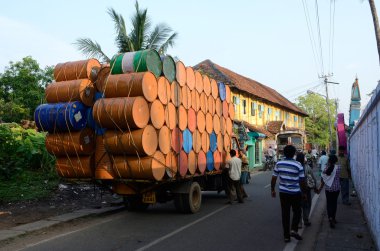indian drivers preparing heavily overloaded truck for travelling at Kerala state on December 6, 2013 in Kochi,Kerala,India. clipart