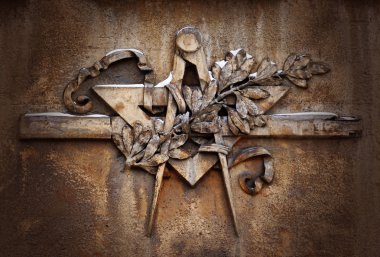 Grunge freemasonry emblem on dramatic background - masonic square and compass symbol, closeup of old architectural building decoration clipart
