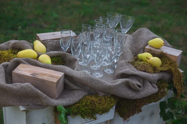 Wedding decor. Wedding on a plate green background and a mountains. Wedding decorations, pears and moss. Tints of green and yellow