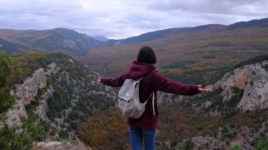 Kadın seyahatte ya da macerada. Genç milenyum yolcusu ya da seyahat blogcusu dağda yürüyor.