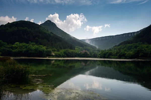 Dark and Foggy lake with hills. after the rain. Beautiful Landscape Of Natural Lake. Travelling and exploring national park.