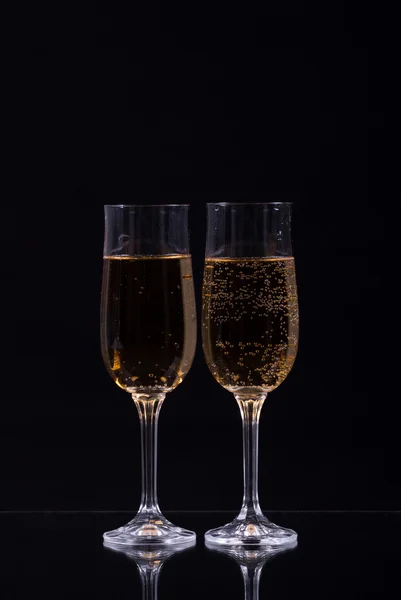 Two glasses of champagne over black background — Stock Photo, Image