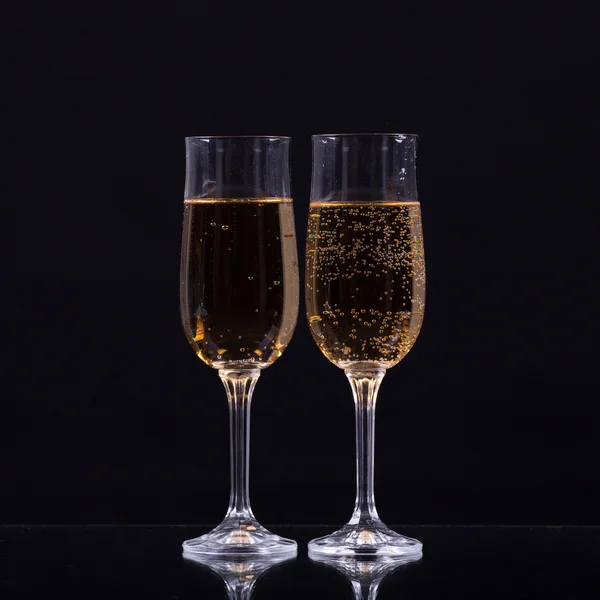 Two glasses of champagne over black background — Stock Photo, Image