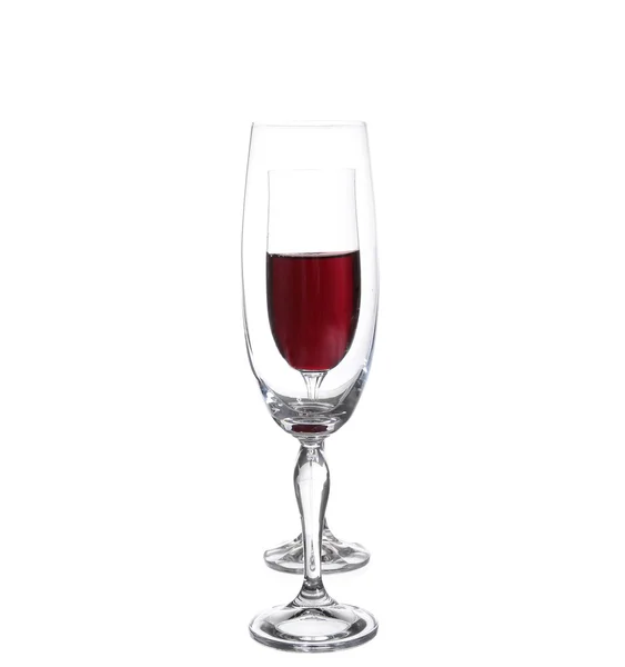 Full and empty champagne glasses with red wine — Stock Photo, Image