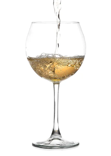 White wine pouring from the bottle intro the glass on white background — Stock Photo, Image