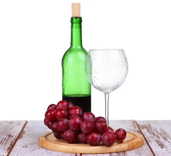 Wine glass with red wine, bottle of wine and grapes isolated over white background — Stock Photo, Image