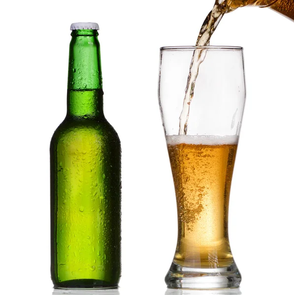 Pouring beer from bottle isolated on white background — Stock Photo, Image