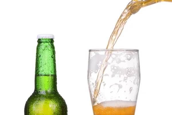 Pouring beer from bottle isolated on white background — Stock Photo, Image