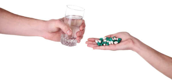 Headache hand with pills medicine tablets and glass of water aga — Stock Photo, Image