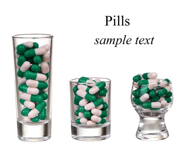 A glass of pills and capsules on white background — Stock Photo, Image