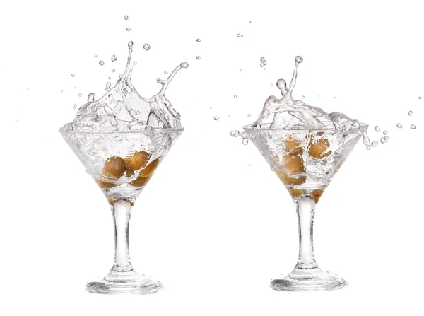Splash from olive in a glass of cocktail, isolated on the white background, clipping path included. — Stock Photo, Image