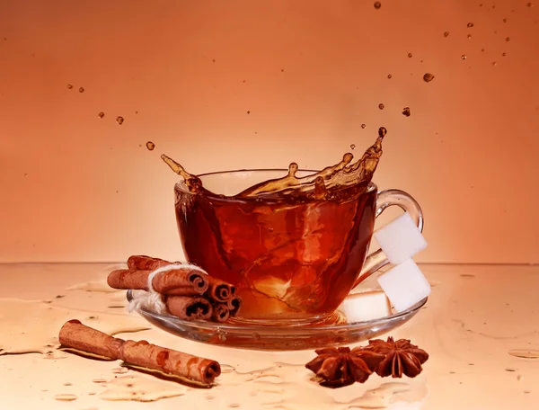 Xícara de chá em vidro com fundo laranja — Fotografia de Stock