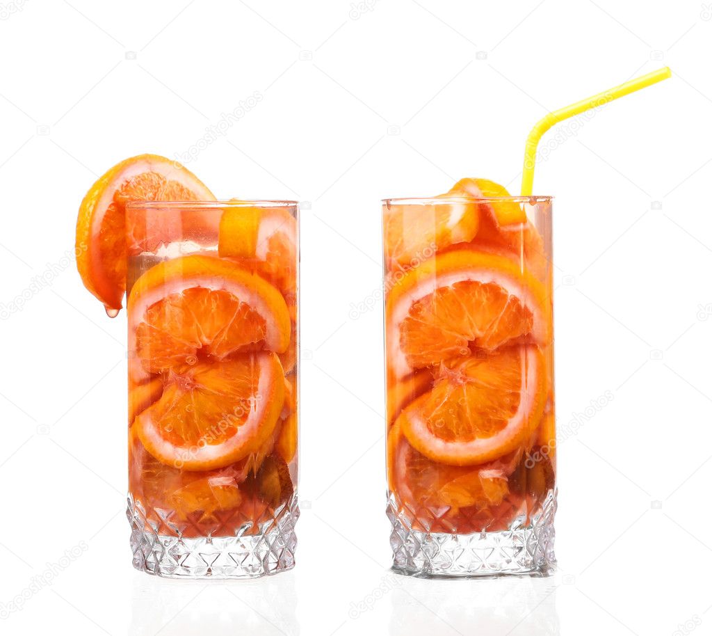 pitcher with a refreshing drink with lemon slices of orange and kiwi on white background