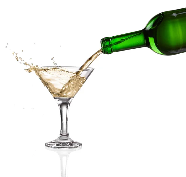 White wine pouring from the bottle intro the glass on white background — Stock Photo, Image