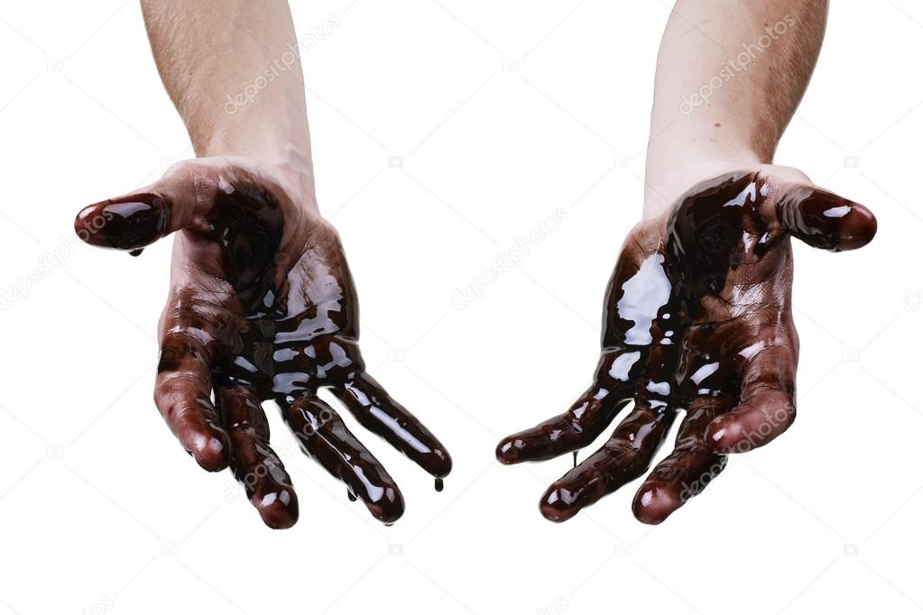 Caucasian hands cupped with black heavy fuel isolated on white background