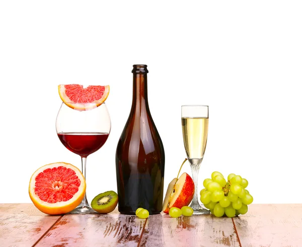 glass of red wine, a bottle of wine and grapefruit on board isolated on white background