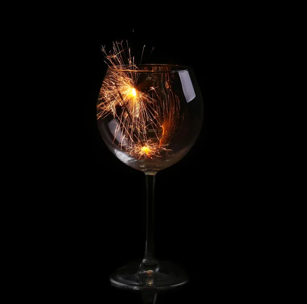 Wine glass with a sparkler. In anticipation of New Year and Christmas — Stock Photo, Image