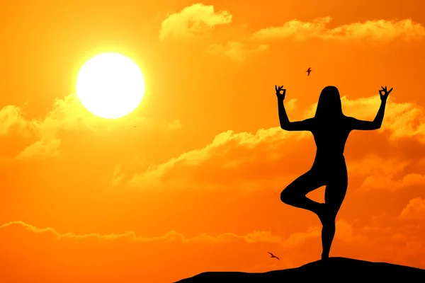 Silueta de mujer practicando yoga al atardecer en la playa — Foto de Stock