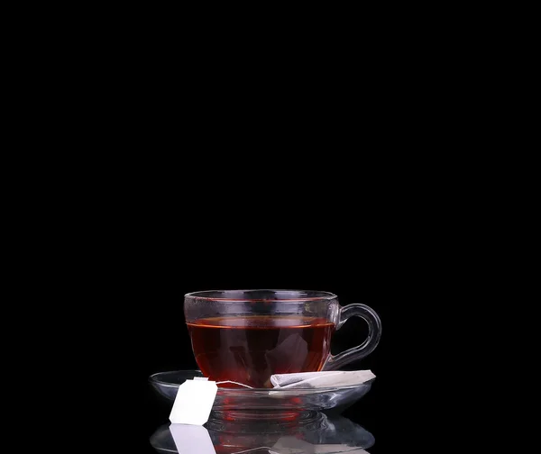 Glass cup on black. Tea bag. Boiling water. — Stock Photo, Image